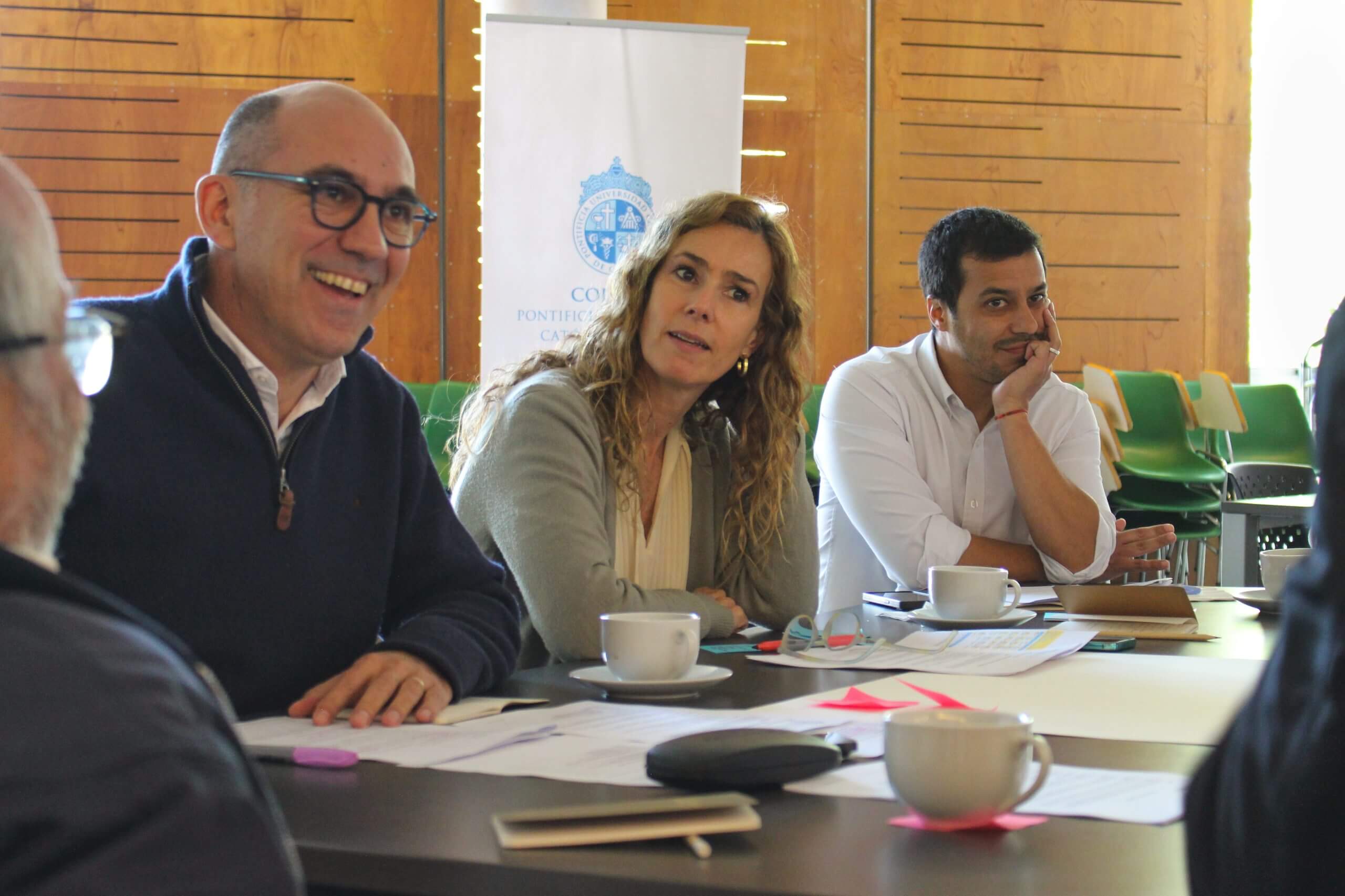 Representantes de empresas sentados en una mesa conversando.